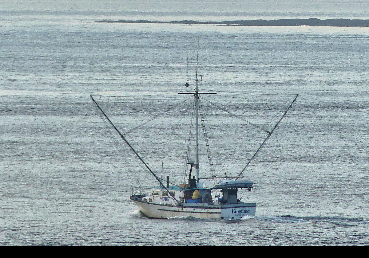 A fishing boat heading out to sea.