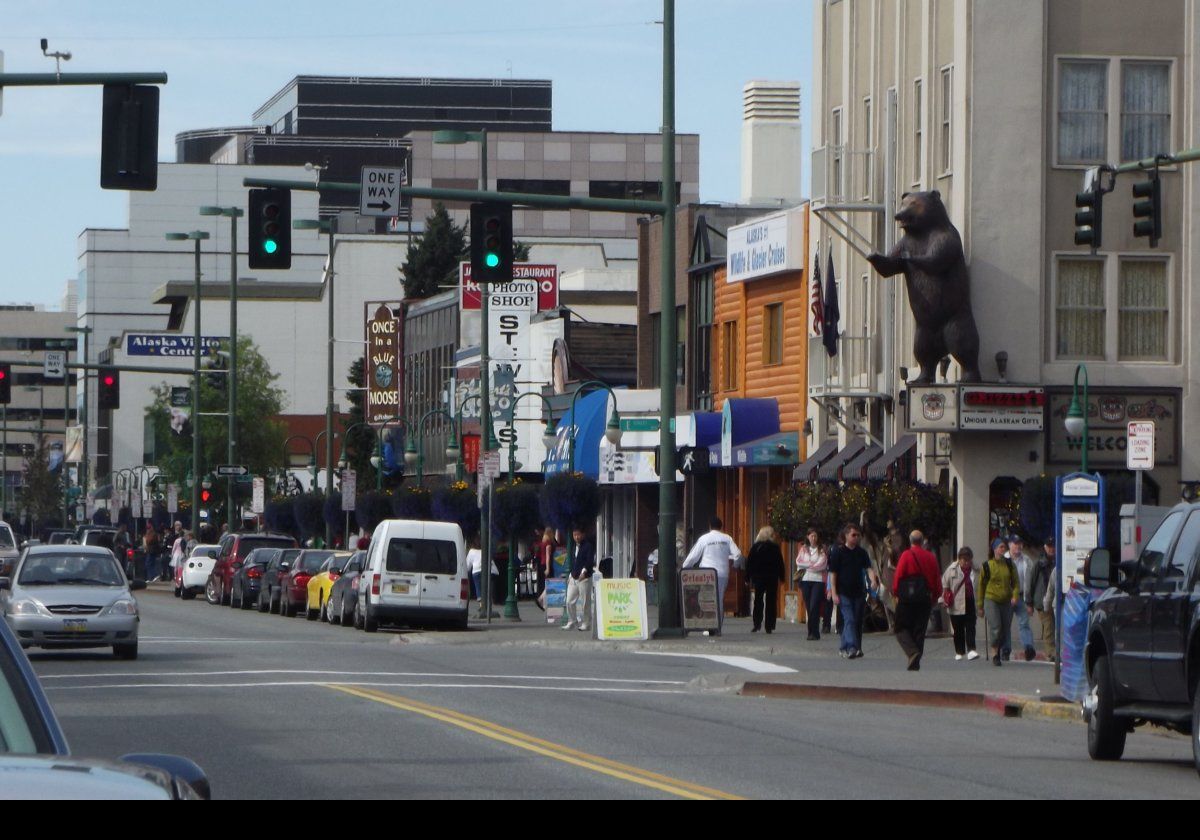 Looking down 4th Avenue. The bear sits above the entrance to Grizzly's, a souvenir shop selling Alaska themed souvenirs, tee-shirts etc.