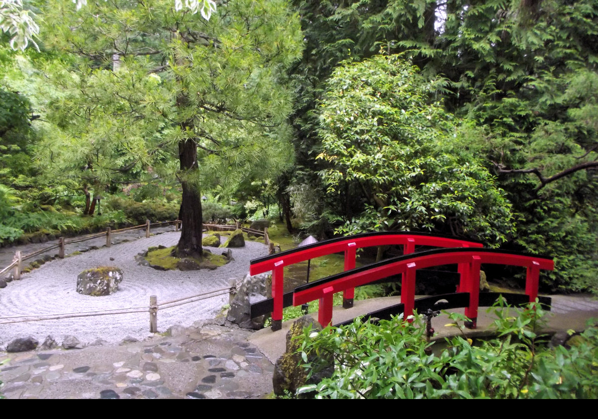 The Zen Garden within the Japanese Garden. The arched red bridge or Guzei represents wisdom & transformation among a number of experiences. Red is also symbolic of Zen encouraging those who cross to move from the physical world to a more spiritual world. It is also very beautiful.