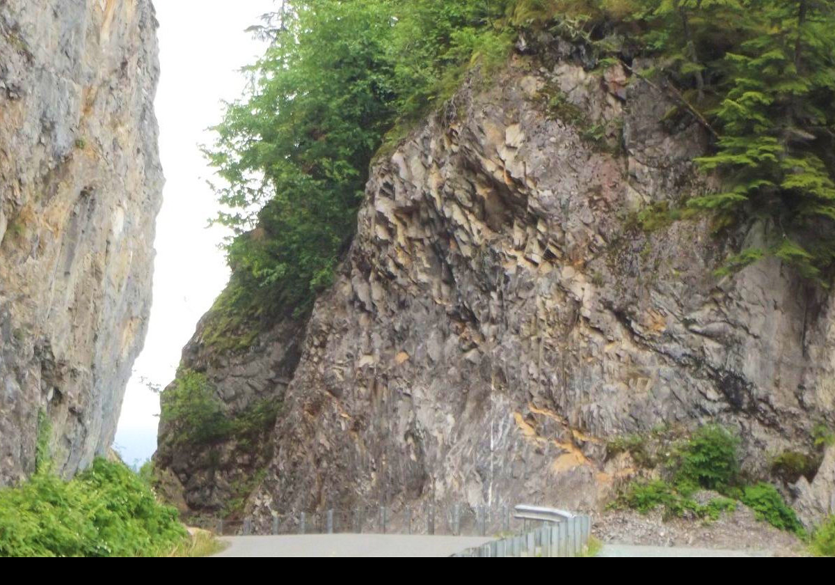 The road has been cut through this huge mass of rock.