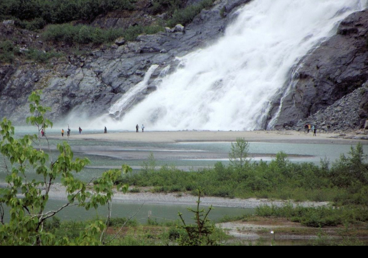 The source of the falls is Nugget Creek, which is fed from the Nugget Glacier. The falls feed into Mendenhall Lake which itself drains into the Inside Passage.