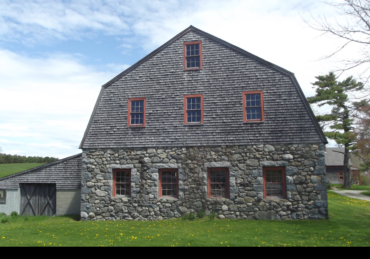 The barn is unusual in having stone for the lower level, a gambrel roof, and clapboarded gambrel ends. 