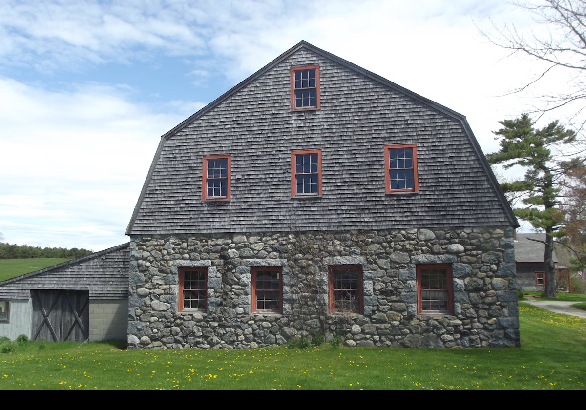 The barn is unusual in having stone for the lower level, a gambrel roof, and clapboarded gambrel ends.