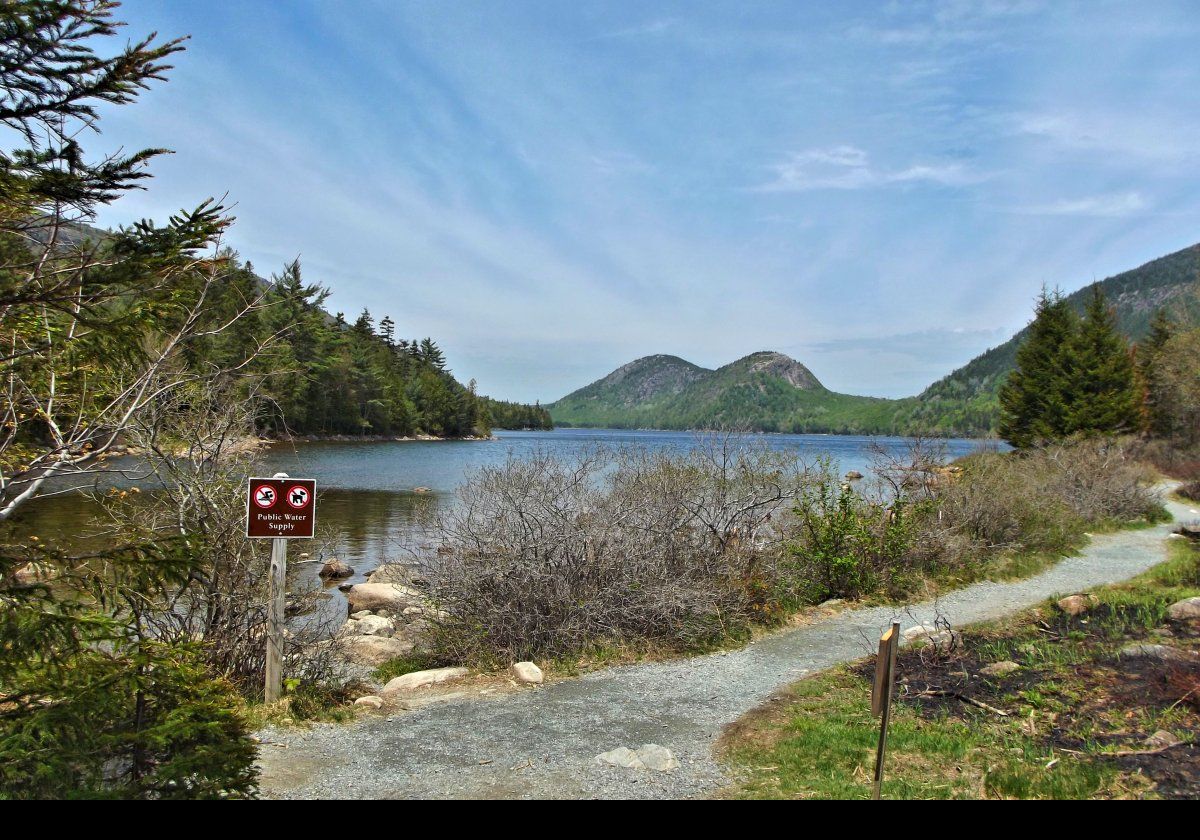 As the sign proclaims, Jordan Pond is the water supply for the village of Seal Harbor, which is about 2 miles, 3 km, to the south. No powered boats, people or pets are allowed in it, though non-powered boats, kayaks etc, are allowed on it.