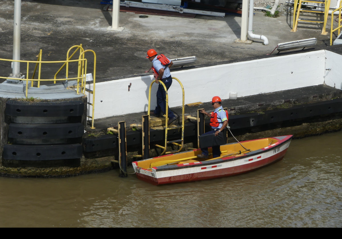 Rowboats are used to carry the light "messenger lines" from the ship to the mules on either side. These light lines are used to pull heavy cables from the ship to attach to the mules..