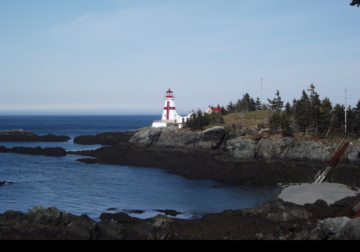 Built in 1829, Head Harbour (or East Quoddy to Americans) Lighthouse sits on a small rocky outcropping just off the northern tip of Campobello Island in Canada. The tower is 51 feet (just over 15.5 meters) tall with a red cross and a red lantern room.