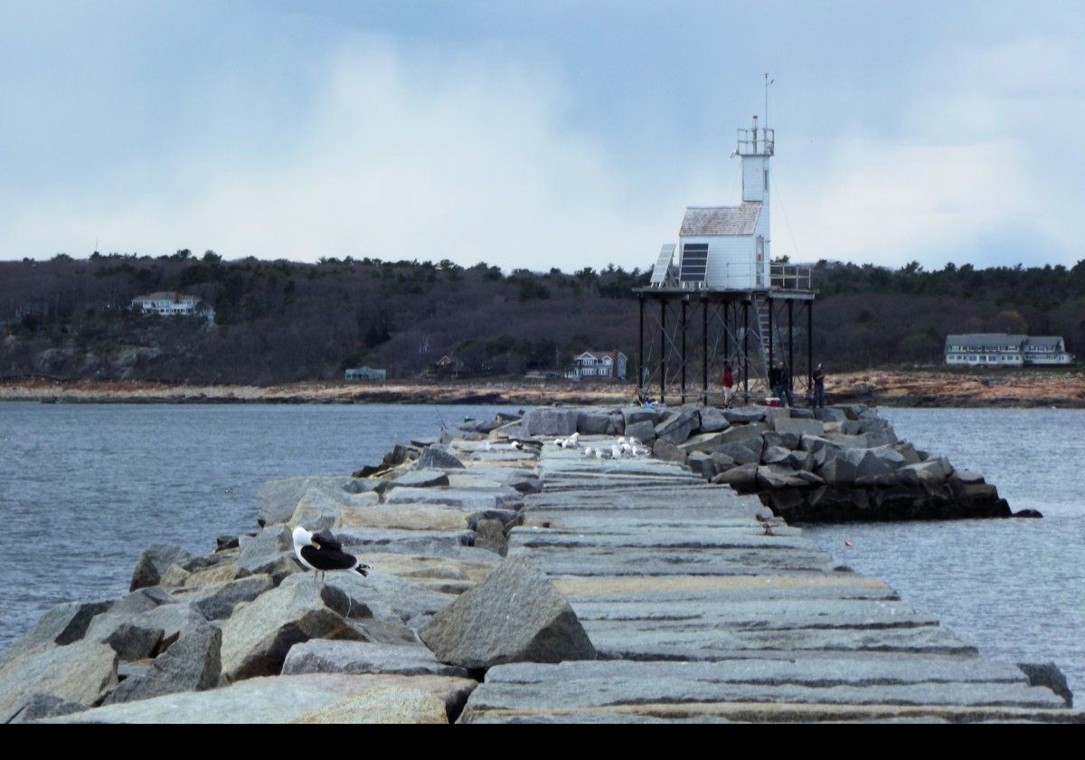 In 1906, the first light was constructed on the breakwater comprising a wooden tripod with a fixed white light It became known as the Gloucester Breakwater or Dog Bar Light.