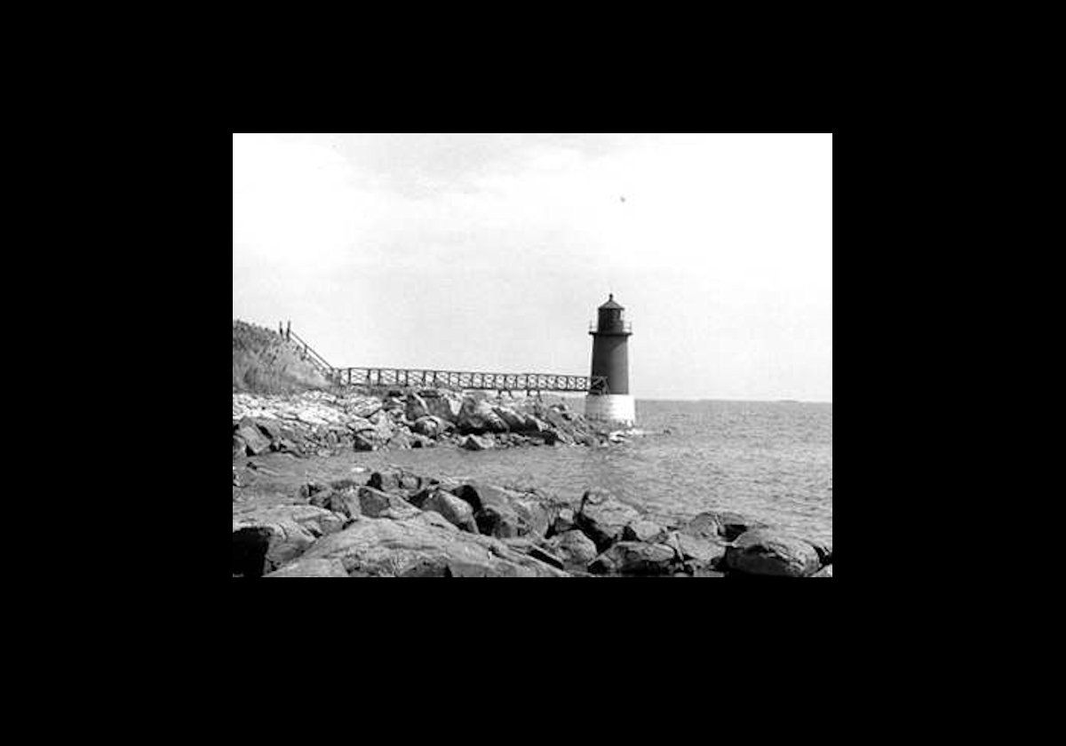 An old Coast Guard picture of the lighthouse with the wooden bridge in place. The bridge was destroyed and rebuilt twicw in 1879 & 1904.