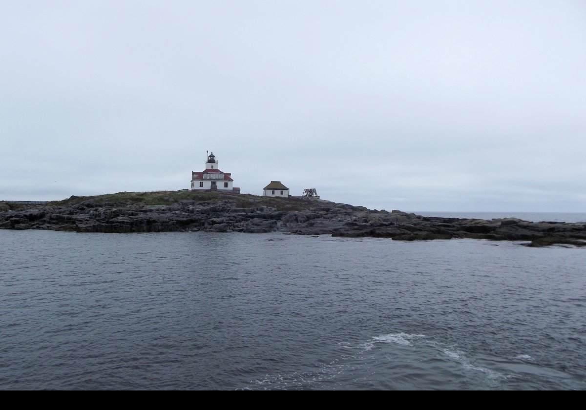 The lighthouse was commisioned in November 1875, using a fifth-order Fresnel lens showing a fixed red light. The keepers house, with the central light tower, was originally a single story.