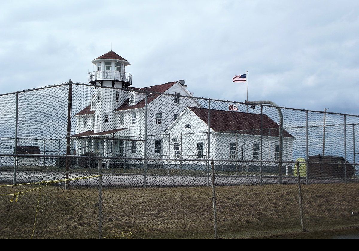 Built in 1937, the large white building to the side of the tower, with the cupola that resembles a lighthouse lantern room, comprises administrative offices for the Coast Guard.  It is off limits to visitors!