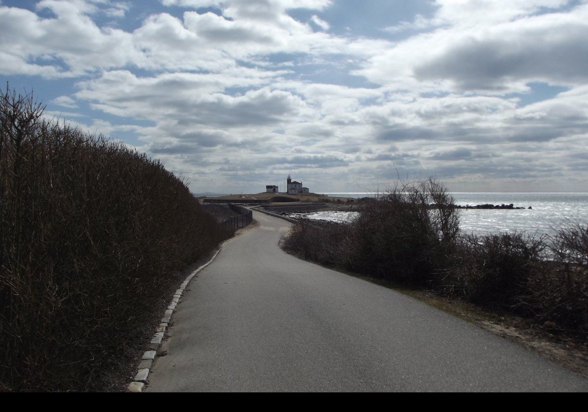 A beacon was established here in 1745 during King George’s War. It was used to warn of possible naval attack using a smoke signal {day) or a fire (night). The beacon was destroyed in 1781 by a storm. A true lighthouse was built in 1806/7. By 1855, erosion of the site necessitated moving the lighthouse back, so a new lighthouse was completed in 1856. Essentially, this is the current structure.