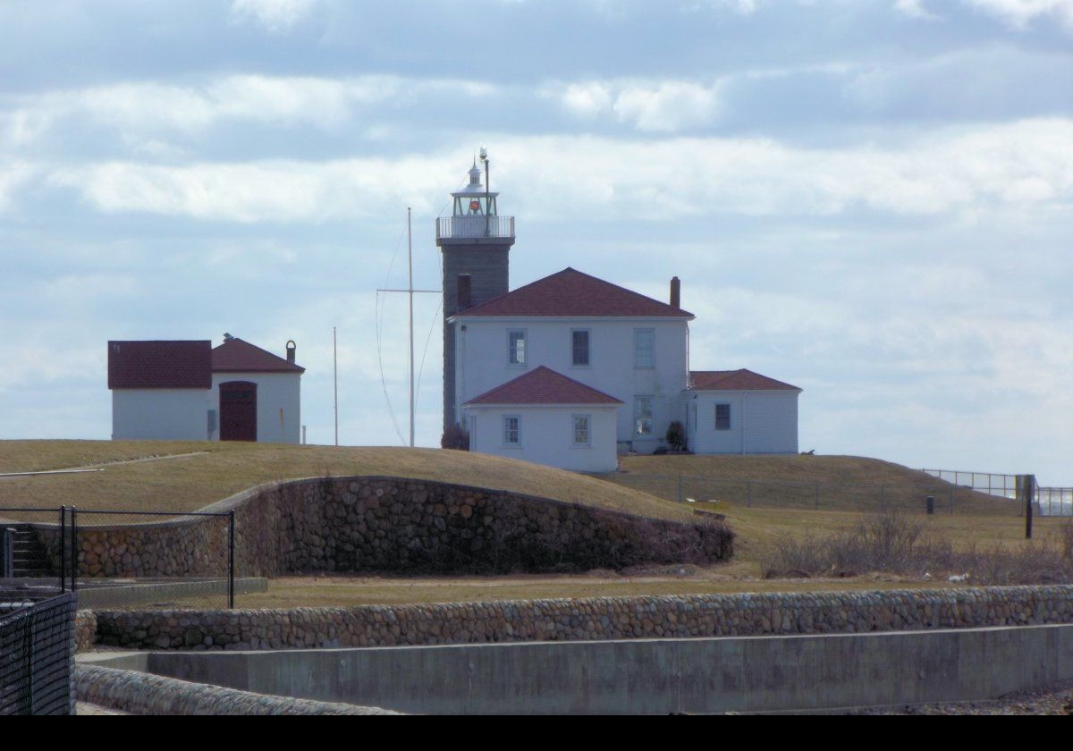 The lighthouse stands about 14 meters (45 feet) tall. The original optic comprised a fixed white light using a 4th order Fresnel lens. In about 1916, the light was replaced by a revolving optic; white light for 10 seconds, then 5 seconds of darkness with 2 flashes of red. A separate fog signal building was added in 1909.