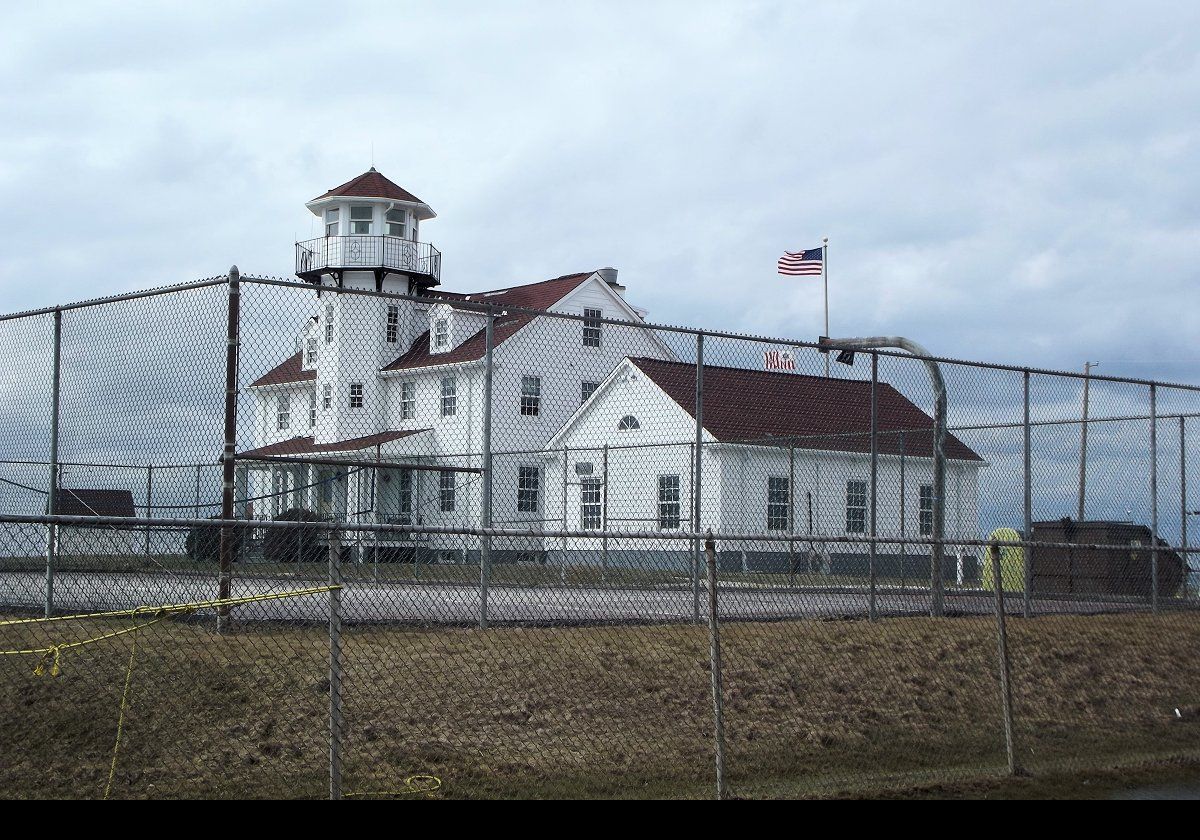 Built in 1937, the large white building to the side of the tower, with the cupola that resembles a lighthouse lantern room, comprises administrative offices for the Coast Guard.  