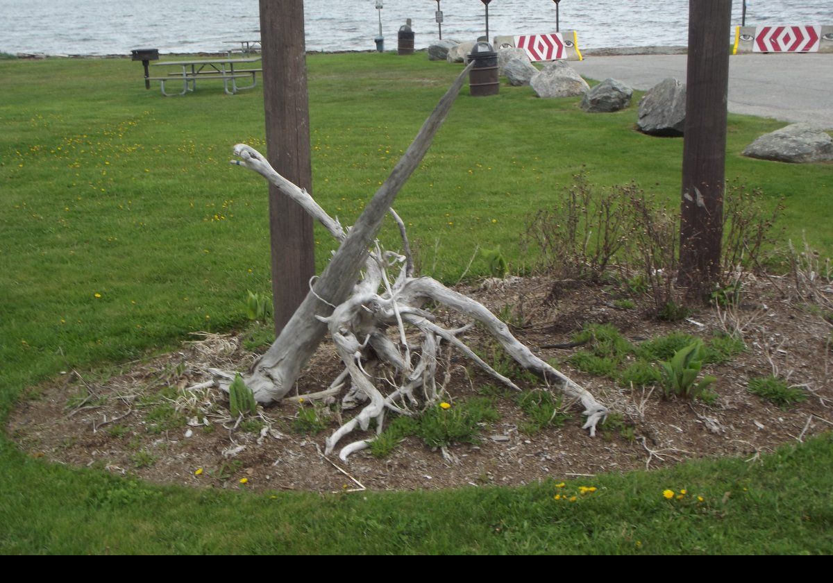 Driftwood piled around the sign post.