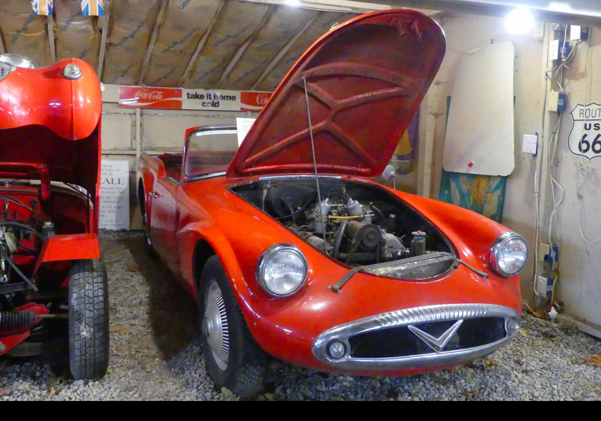 A Daimler SP250 "Dart", built from 1959 to 1964. It used a small 2.5-litre Hemi-head OHV V8 engine with twin SU Carbs.  Many people consider it ugly.  I beg to differ.