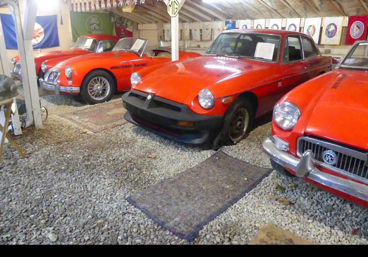 A pair of MGAs on the left, and a pair of MGBs on the right, the GT with the truly awful black bumpers required for the US market.