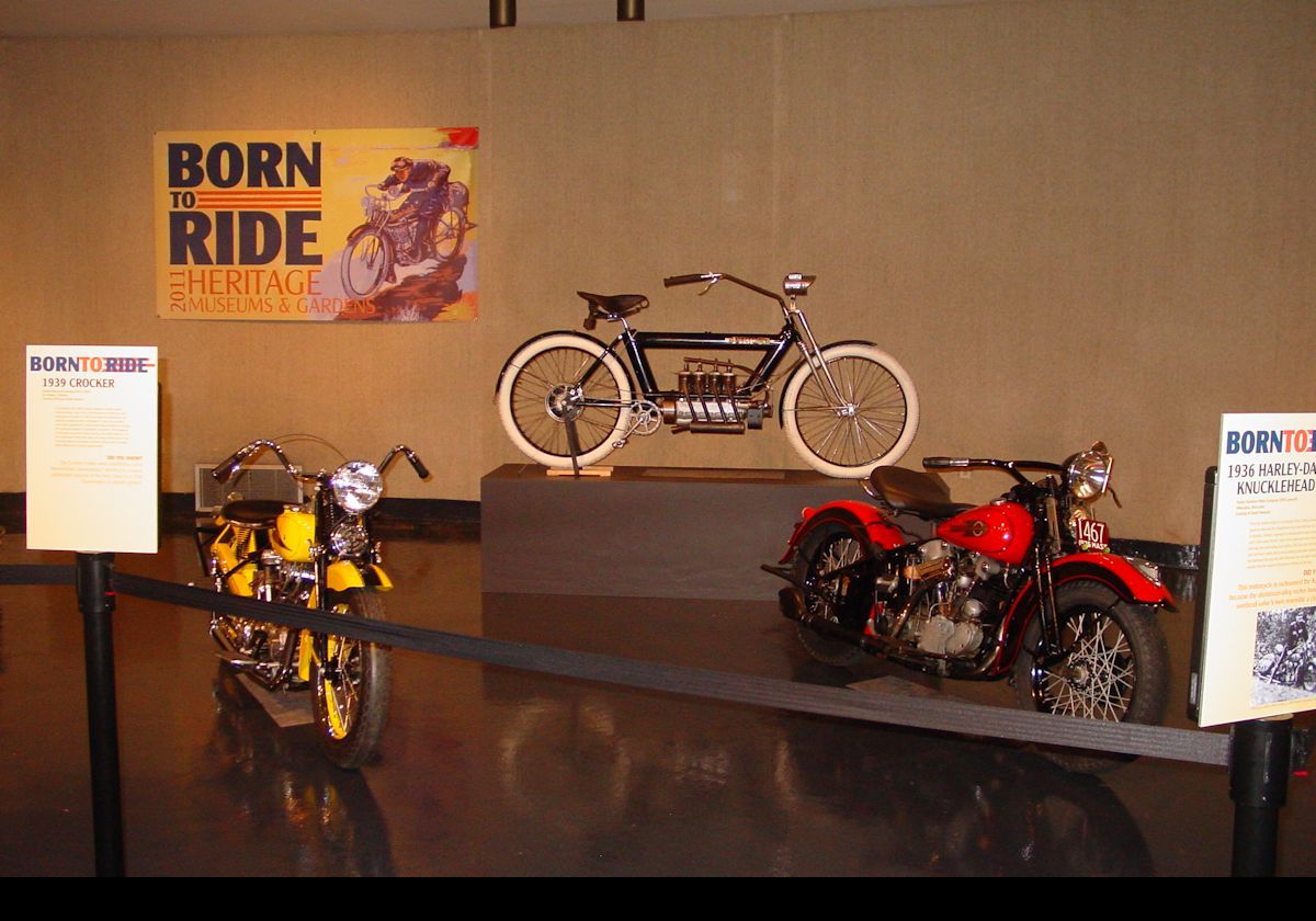 The Harley-Davidson on the right is a 1936 Knucklehead; the first year of production. It had a 1,000 cc, twin cylinder, OHV engine. It cost about $380, and is now worth upwards of $12,000. The Crocker to the left is 1,200 cc also with a twin cylinder OHV engine.