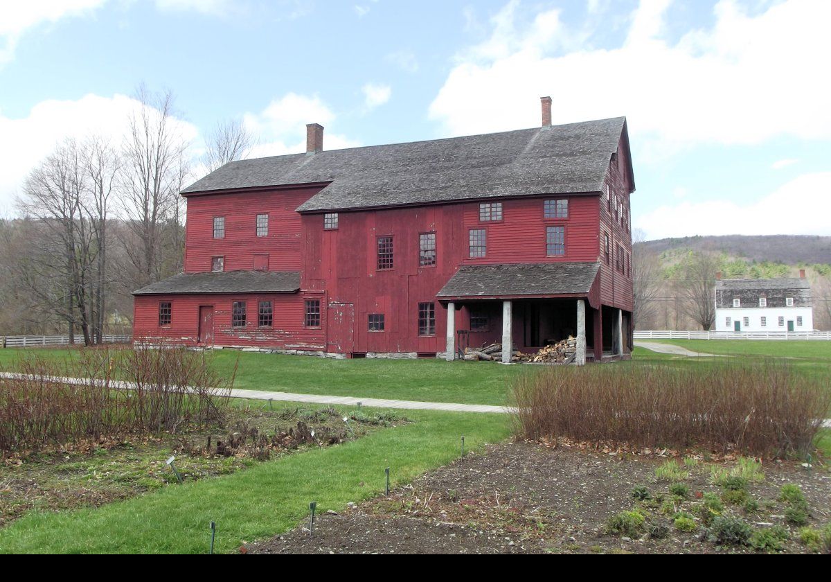 The Laundry and Machine Shop. The white building behind and to the right is the Meeting House.