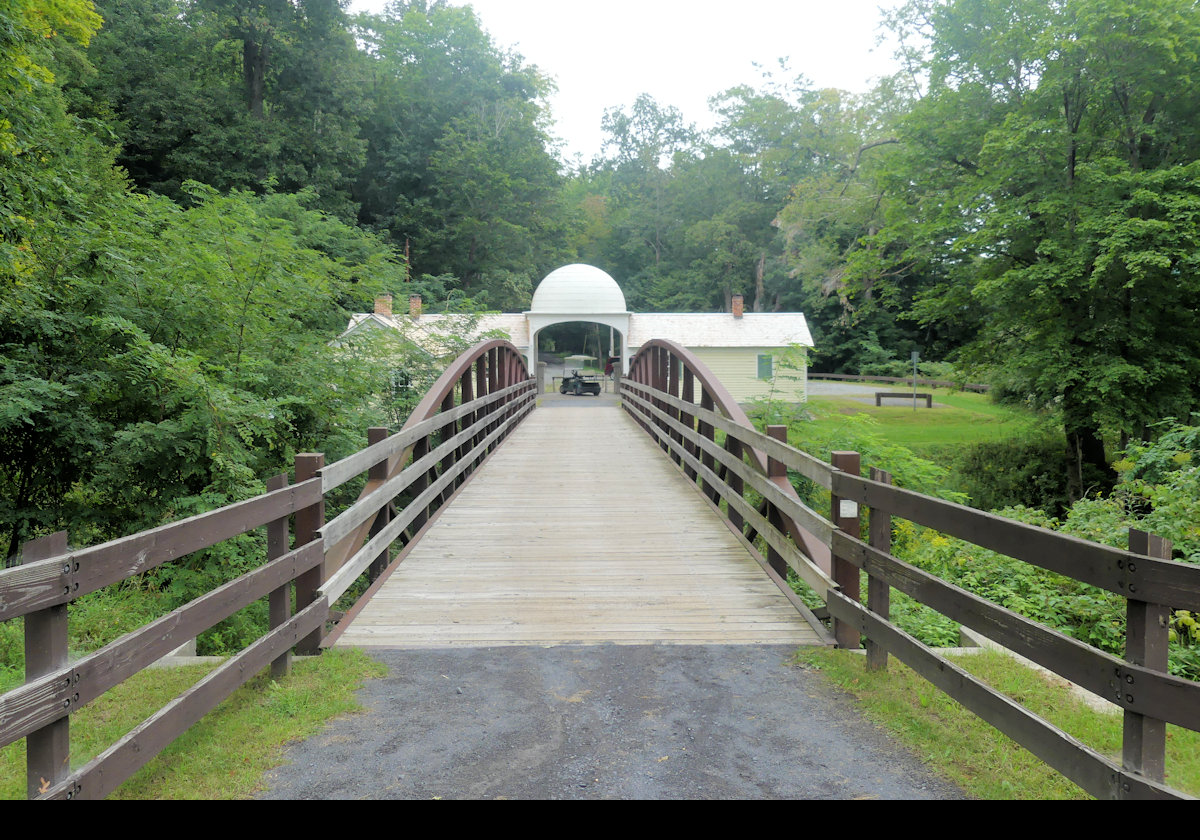 Looking across "Tin Top Bridge" towards "Tin Top", Hyde Hall’s original Gatehouse.  Originally, this was the entrance to the grounds of Hyde Hall, which were more extensive than today.  It is named "Tin Top" for its tin covered cupola