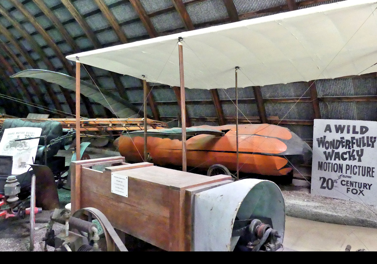 The "Passett Ornithopter" from 1912.  Intended to fly by flapping its wings like a bird.  This one, the orange contraption in the background, was built for 20th Century Fox, and used in "Those Magnificent Men in their Flying Machines"