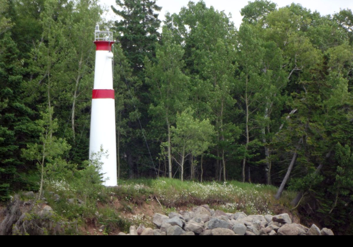 Built in 1976, this is the Kidston Island West End Lighthouse.  As its name suggests, it sits on the west end of Kidston Island.  It comprises a tapered white fibreglass tower with 2 red bands, and shows a flashing red light. 