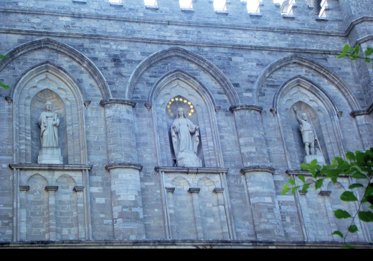 Figures above the main entrance to Notre-Dame Basilica.