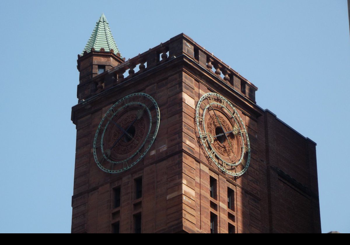The ornate clock tower of the New York Life Insurance Building (or Quebec Bank Building) at 511 Place d'ArmesIt was constructed between 1887 & 1889.  It is built from red sandstone that was imported from Dumfriesshire in Scotland.