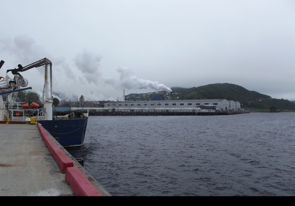 On land, and ready to explore Corner Brook. The low, gray buildings are part of the Corner Brook Pulp and Paper mill.