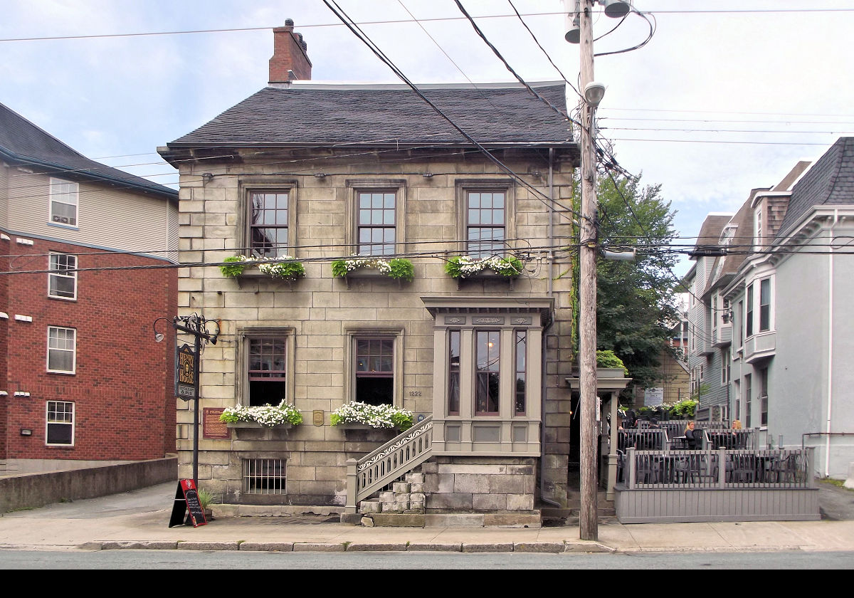 Henry House on Barrington Street. It was built in 1834 for John Metzler, a local stonemason, and was home to William Alexander Henry, a co-author of the British North America Act, between 1854 & 1864. Used as a sailors' home in the late 19th and early 20th centuries, it became a restaurant in 1968, and continues as such.