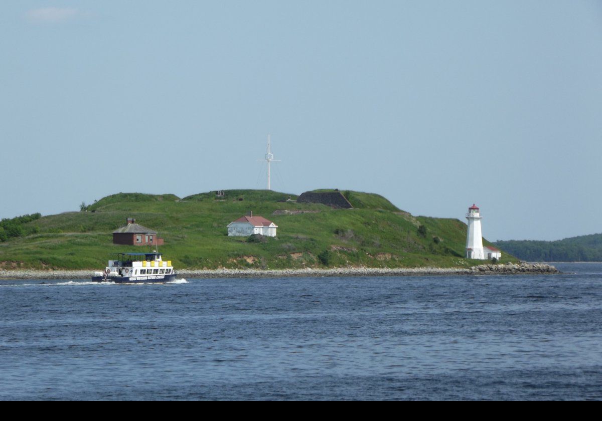 Named after King George II, the current Georges Island Lighthouse was built in 1917 replacing an earlier one built in 1876 that burned down in 1916. The keeper's house from 1917 remains standing. A 4th order Fresnel lens was mounted in the old lantern room in 1913. A 270° degree 4th order Fresnel lens was used in the new lighthouse, and it was automated in 1972.