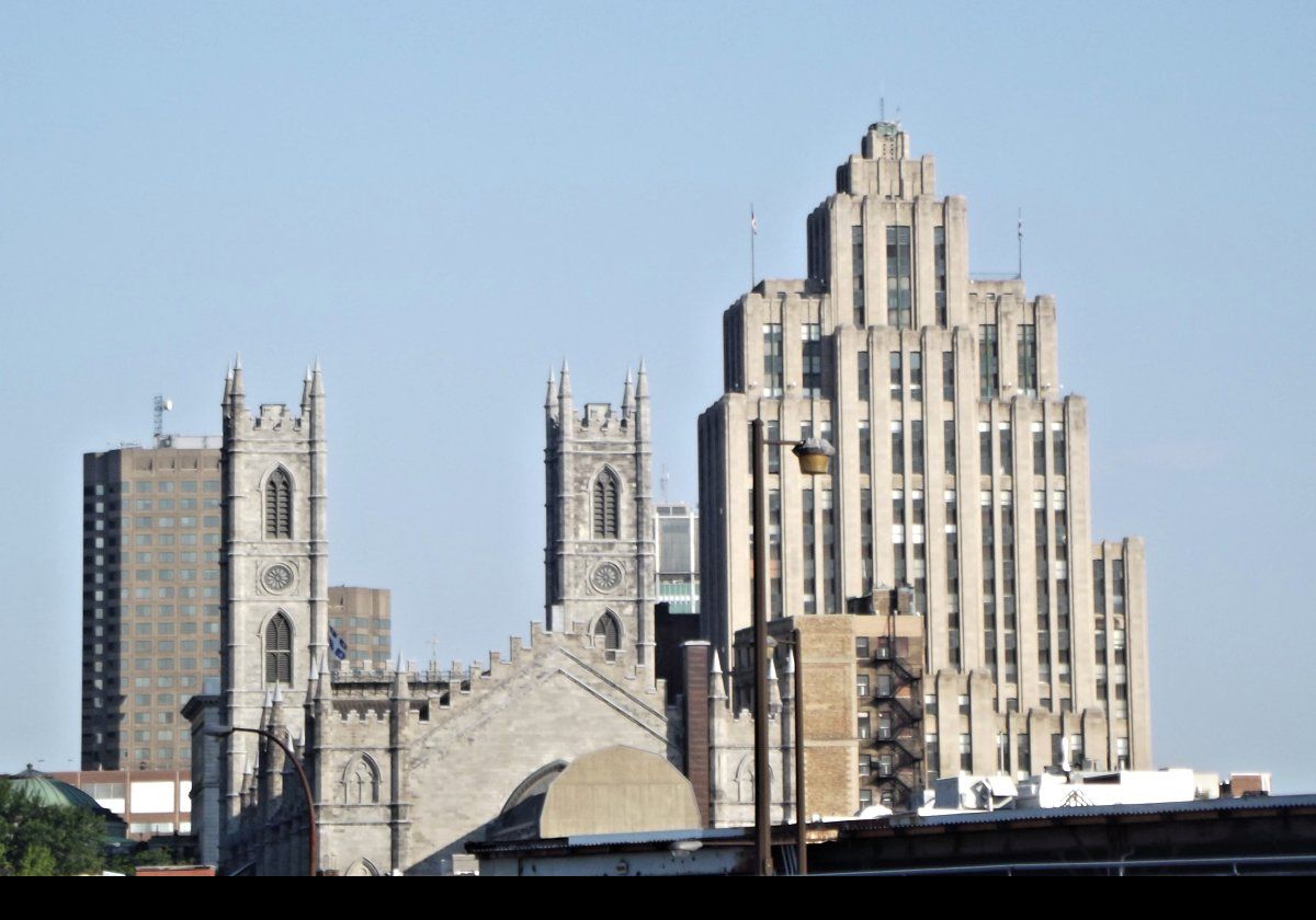 To the left, Notre-Dame Basilica.  To the right, the Aldred Building (Édifice Aldred) in Place d'Armes square.  Completed in 1931, the same year as the Empire State Building in New York City, it is 96 metres (316 ft) tall, comprising 23 floors.