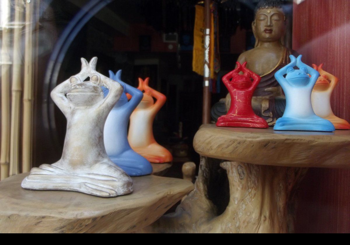 Strange; frog figurines in lotus position juxtaposed with Buddah.