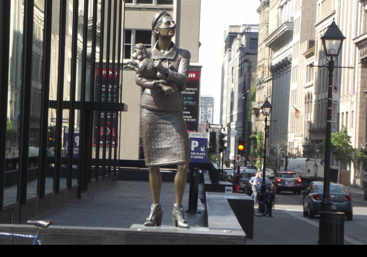 The English Pug and the French Poodle; one of a pair of sculptures by Marc Andre Jacques Fortier.  Located in front of 500 Place d'Armes.  Click the image to see a closeup of the plaque.  