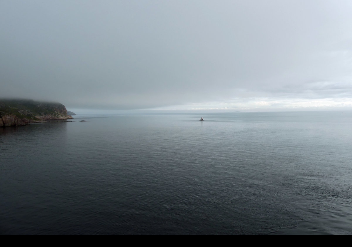 Arriving at Saint Pierre & Miquelon in the early morning with a low lying mist. The next image is a slightly hazy close-up of the lighthouse seen in the distance.