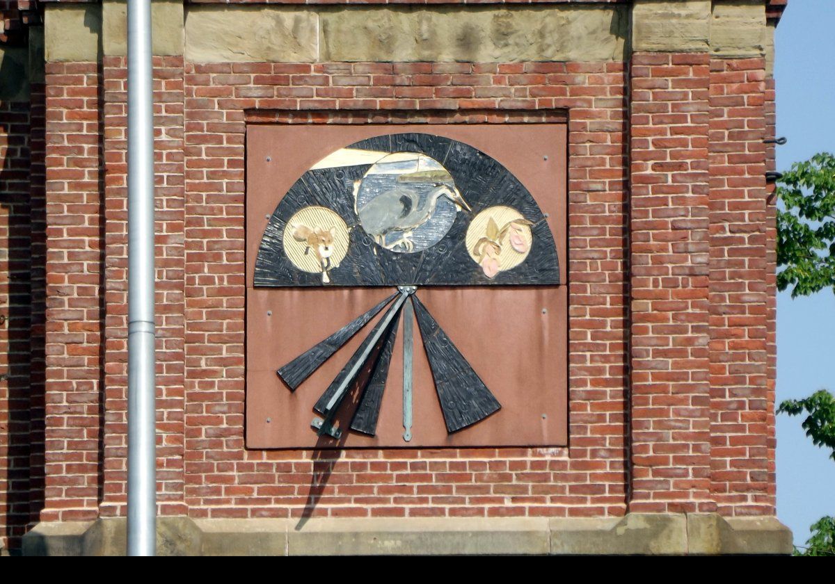 A closeup of the decoration on the tower of the City Hall building.