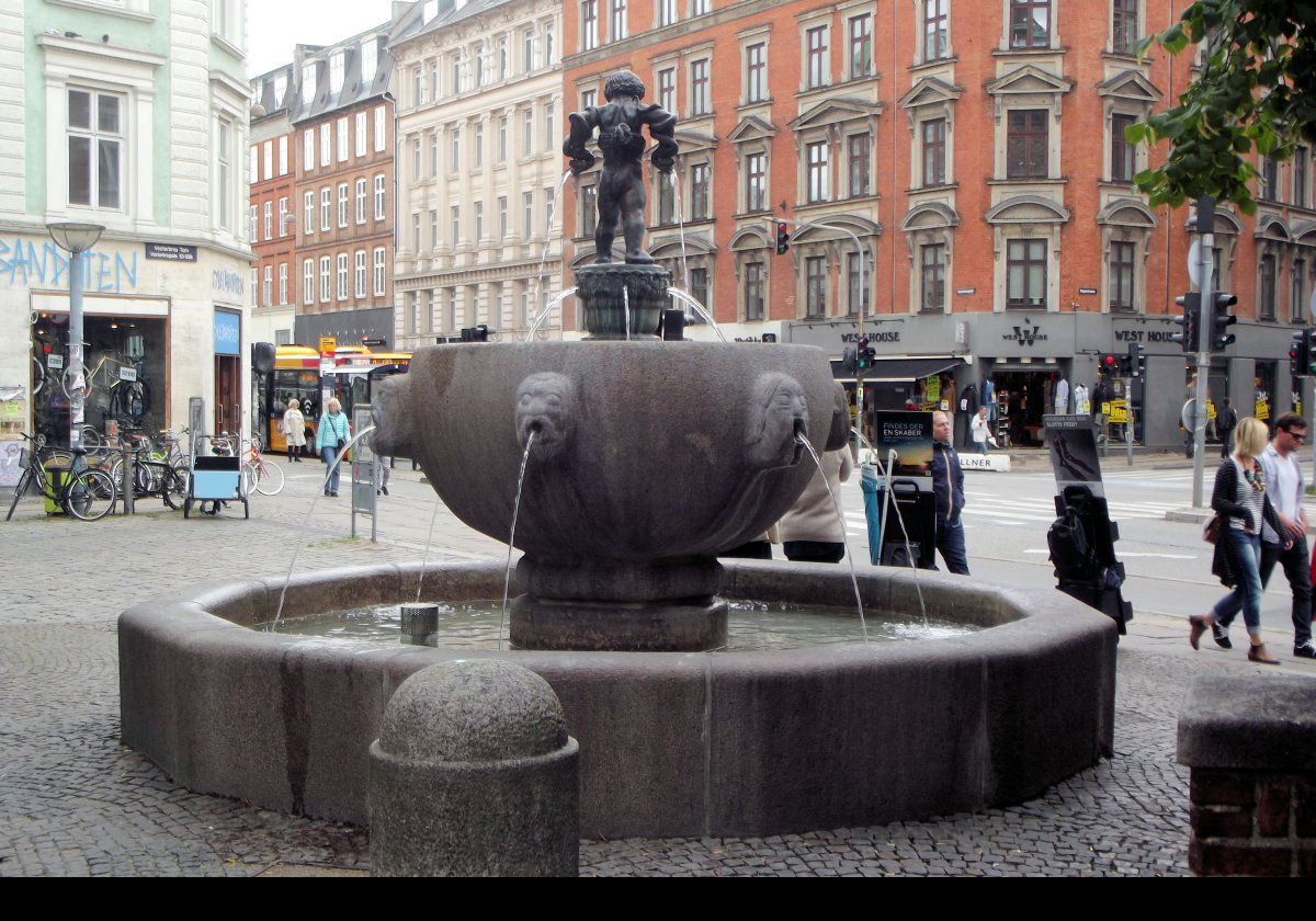 The Hercules Fountain built in 1915 and designed by the sculptor Rasmus Harboe. He also designed the reliefs on Eliah's Church on the other side of the square.