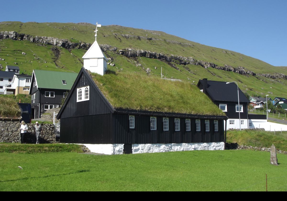 The village church in Kollafjørður.  It is a typically Faroese wooden church, painted in black with a turf roof, that was built in 1837.  