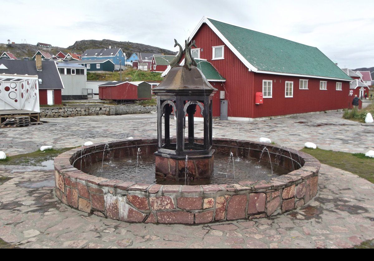 Completed in 1932, Mindebrønden is the oldest fountain in Greenland.  There are four whales on top of the fountain spouting water from their blowholes.  Click the image for a closer view.