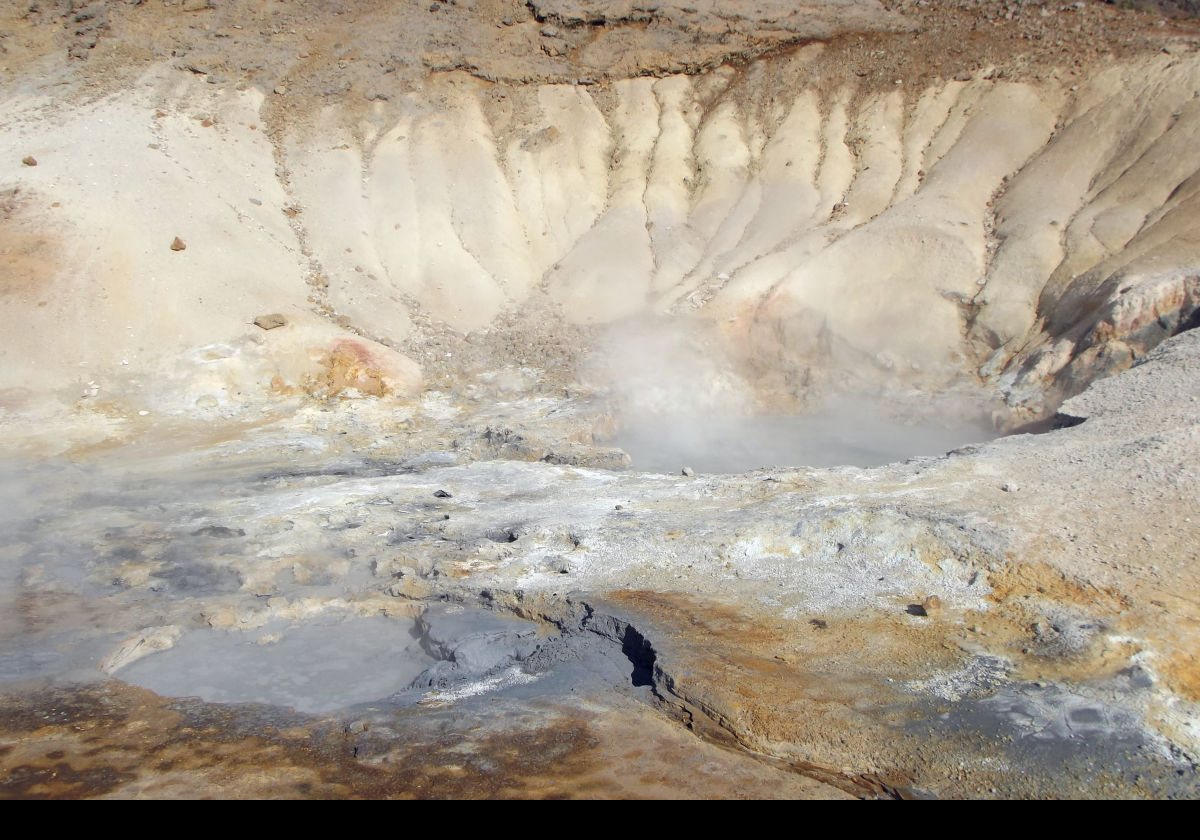 Krísuvík moonscape of bubbling sulfuric mud pools and steam vents.