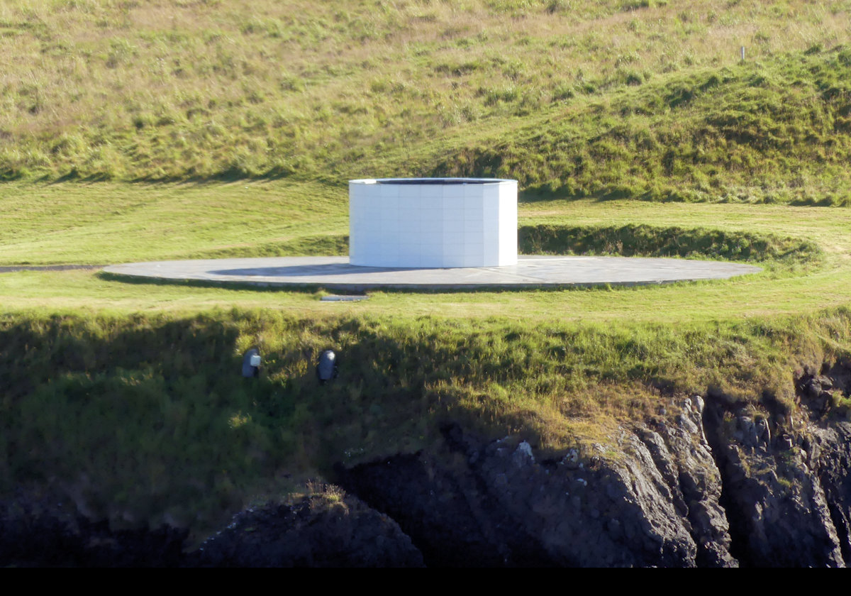 The Imagine Peace Tower in daylight.  It is the memorial to John Lennon from his widow, Yoko Ono on Viðey Island.  At night it lights up with 15 searchlights that reach up to 4,000 meters (nearly 2.5 miles) upwards.