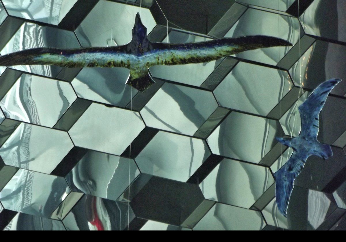 These large glass birds hanging from the roof of Harpa were created by Tróndur Patursson.  Initially a sculptor. he has since become better known as a painter and glass artist.