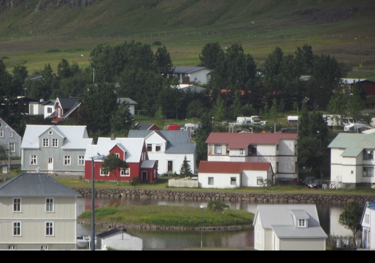 Homes around the Fjarðará, the little lake in Seydisfjordur that is fed by the Fjardara river that feeds, in turn, into the fjord. There is a small, seemingly un-named, island near the center.