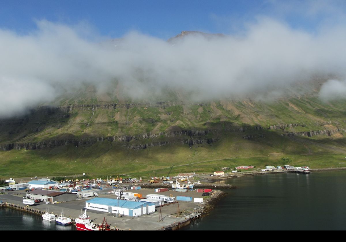 A view of the dock with one of the mountains peeping above the low cloud.