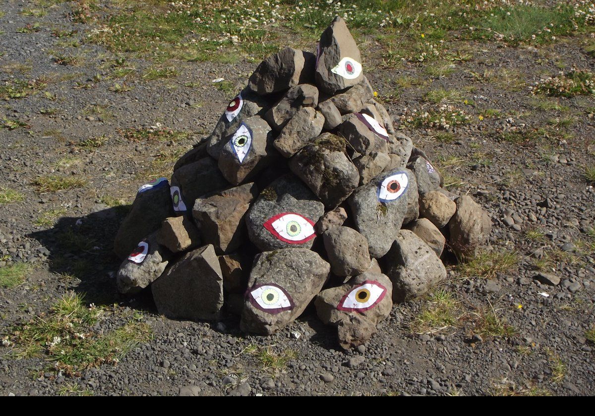 A colorful sculpture on the side of the road.