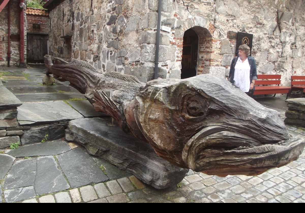 Wood carving of a large mythical sea creature in Bryggen, the historic waterfront area.