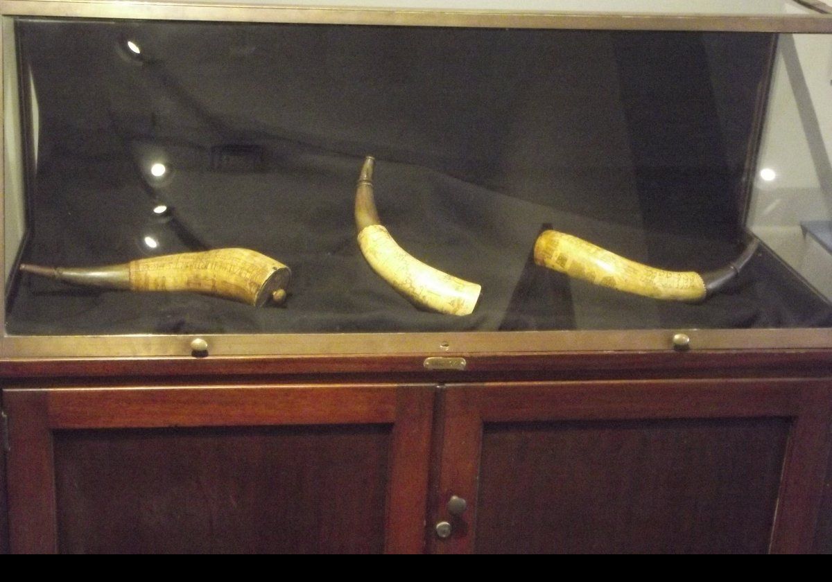 Engraved powder horns. Some of the engravings show marching troops, and one has a map of the Hudson River.