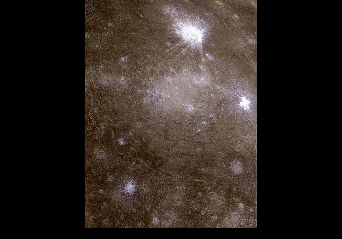 The Asgard impact basin.  The center is the bright region near the middle of the picture, and it is surrounded by concentric rings to about 1,600 km across, with many small craters superimposed on it.  The very bright areas (top & right) are more recent craters where the ejected material is ice.  A Galileo image from 1997.  Credit: NASA/JPL/University of Arizona