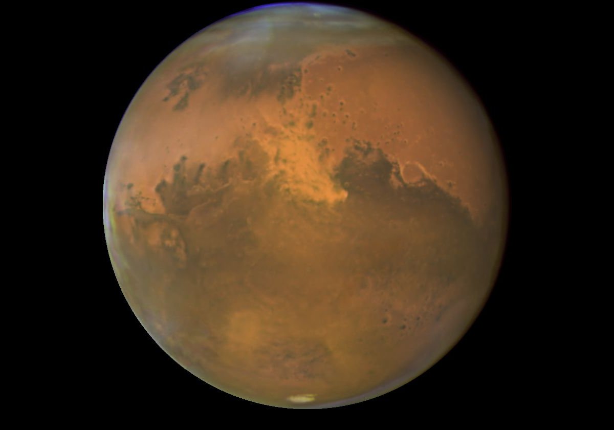 Hubble Space Telescope, true color image taken June 26, 2001, when  Mars was approximately 43 million miles from Earth.  The photograph shows features as small as 10 miles across.  Note the huge dust storm over the north pole at the top of the picture.  Credit: NASA and The Hubble Heritage Team (STScI/AURA)
