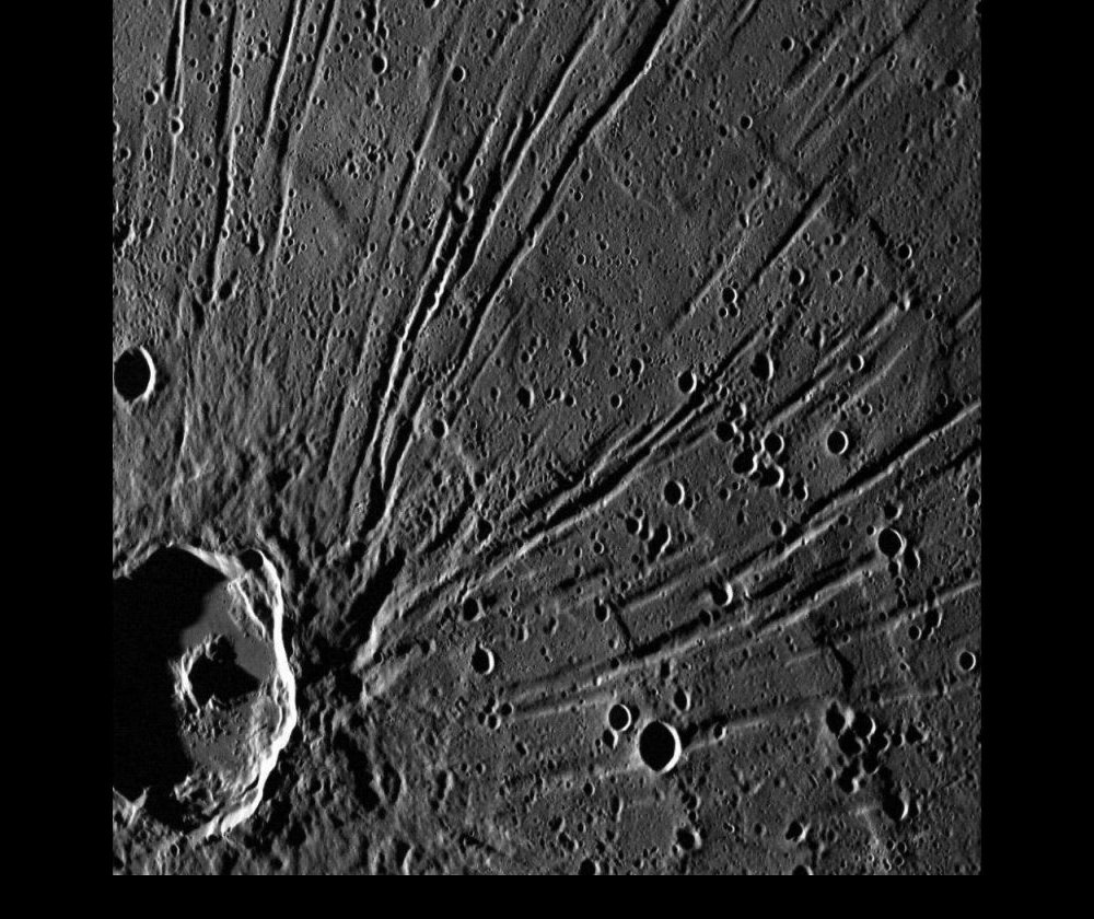 Part of the Pantheon Fossae with the crater Apollodorus, shown in the lower left of the image, which is at its center.  Whether the crater is part of the cause of the Pantheon Fossae or whether it is a later event that happened to occur near the center has yet to be determined.  Taken by Messenger in 2011.