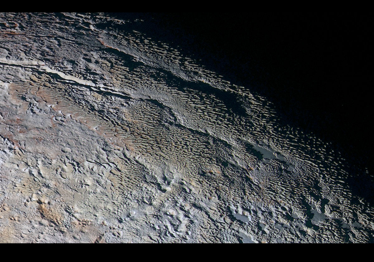 A New Horizons image, about 530 km/330 miles across, showing rounded and bizarrely textured mountains (the Tartarus Dorsa) that rise up along Plutos day-night terminator. There are intricate patterns of blue-gray ridges with reddish material in between. Resolution is about 1.3 km/0.8 miles. Credit:NASA/JHUAPL/SWRI